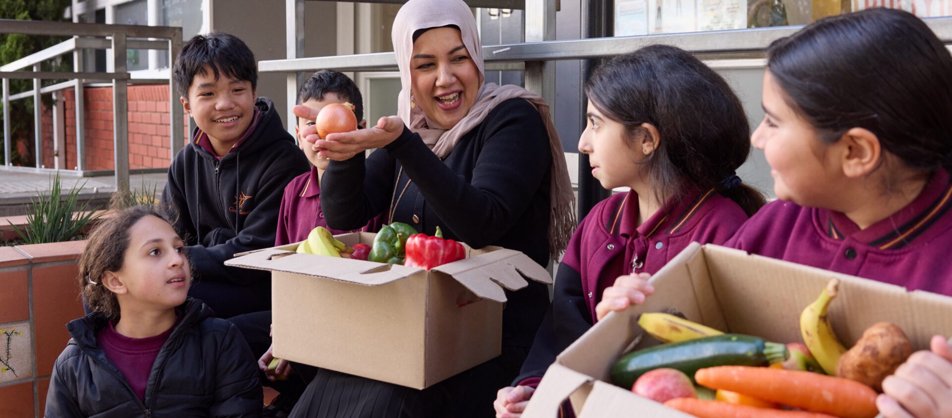 School staff and families with fresh food boxes
