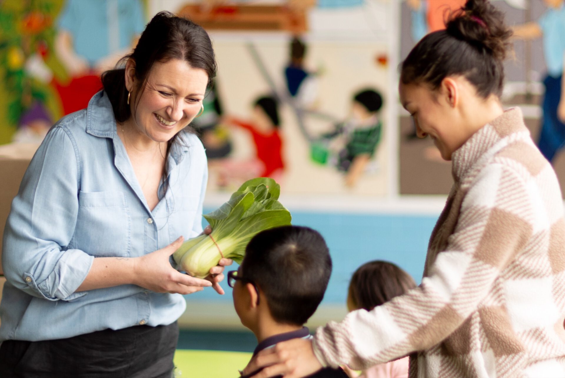 A teacher sharing fresh fruit with a student