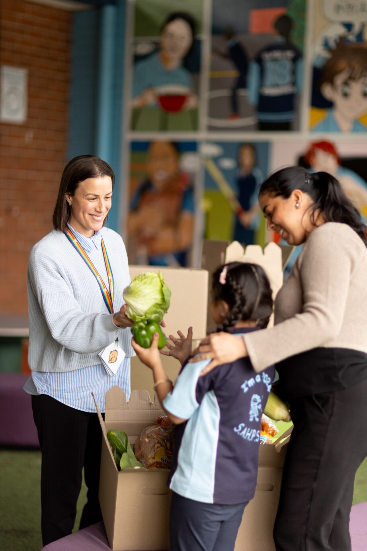 A teacher and a parent sharing fresh produce