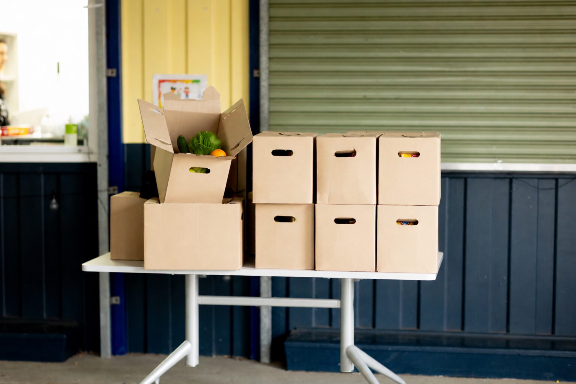 Stacked Fresh Food Project boxes ready for collection