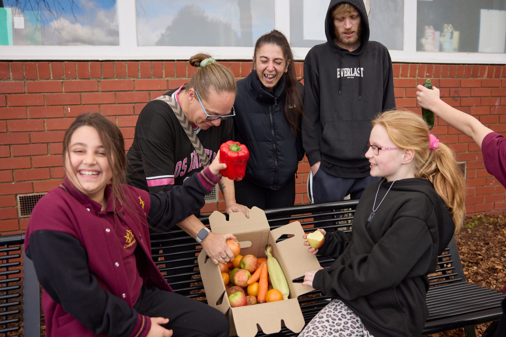 School staff and families with fresh produce boxes