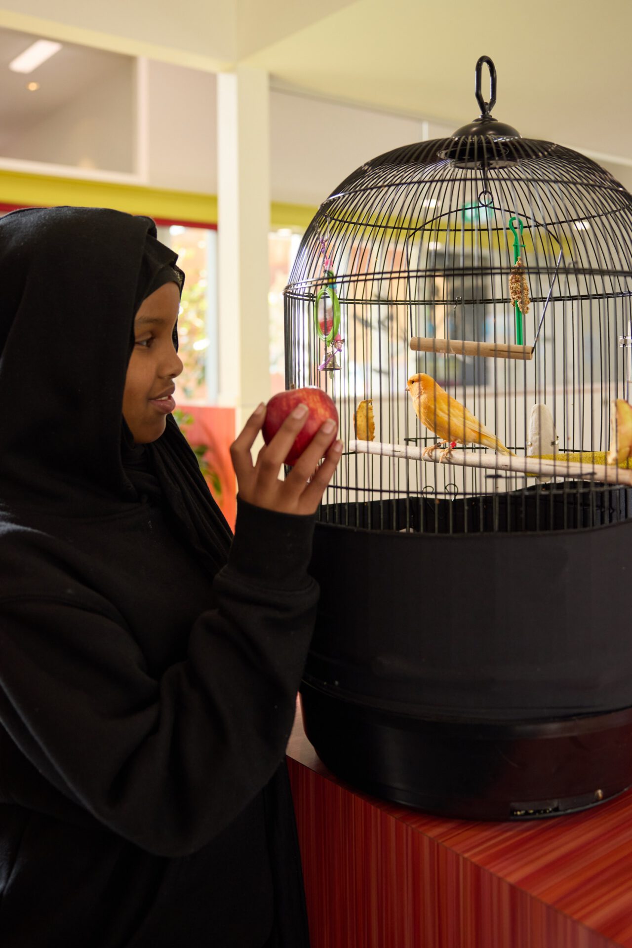 A student holding a red apple