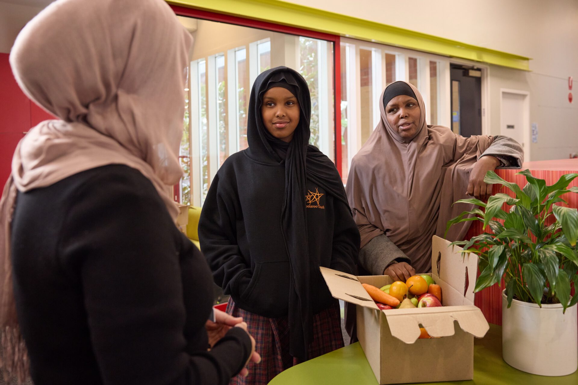 Families collecting fresh food boxes at school